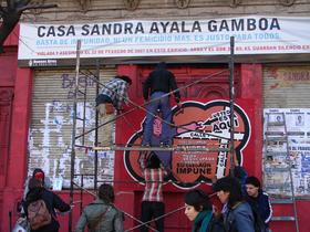 Banner que imita señalización oficial de ARBA, renombrando el lugar del femicidio como Casa Sandra Ayala Gamboa